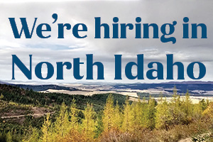 Background: Rolling Landscape with grasses and mountains - Caption: We're hiring in North Idaho