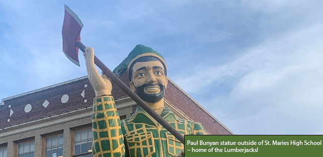 Background: St. Maries High School - Caption: Paul Bunyan statue outside of St. Maries High School – home of the Lumberjacks!